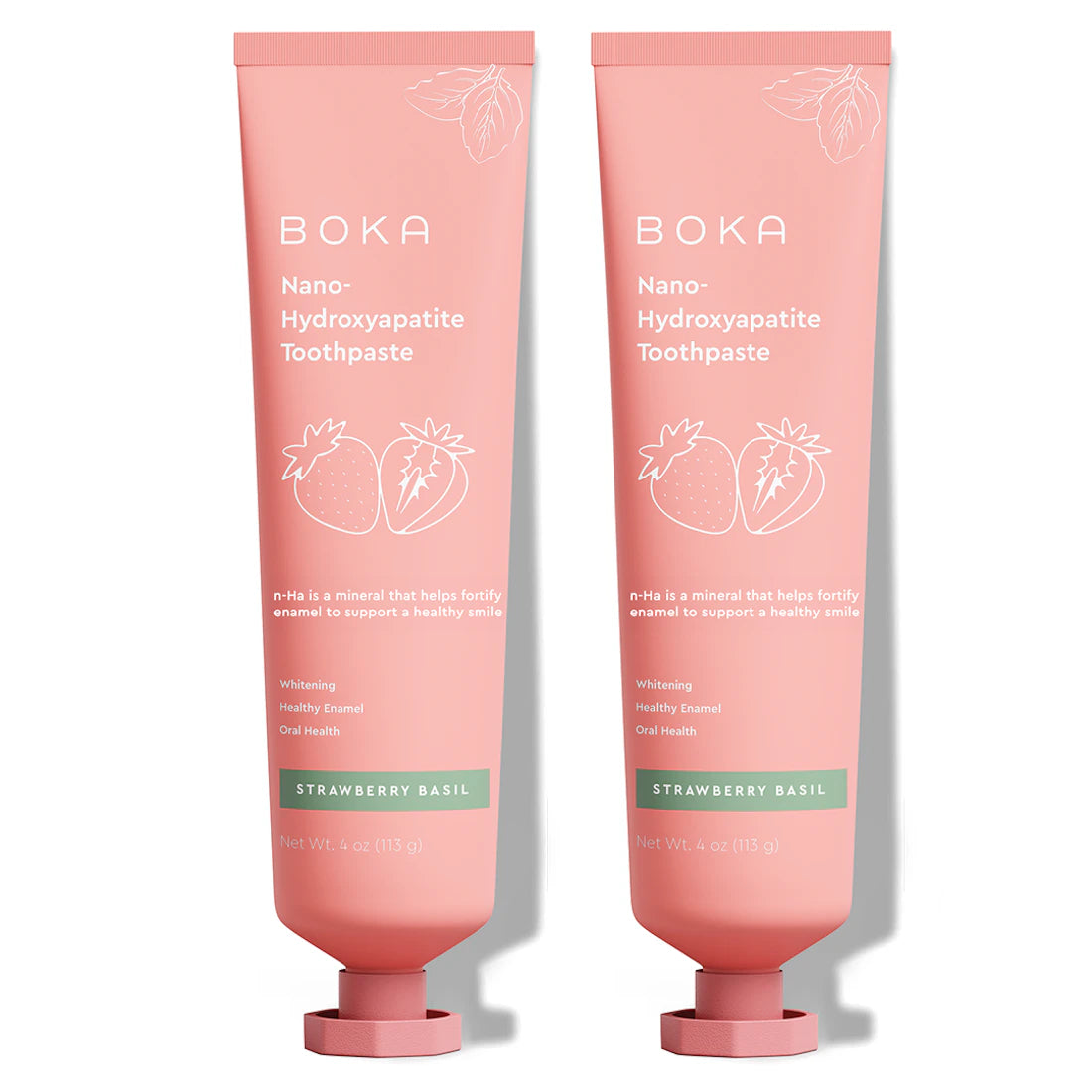 Two pink tubes of Strawberry Basil n-Ha Toothpaste with strawberry graphics, fluoride-free.