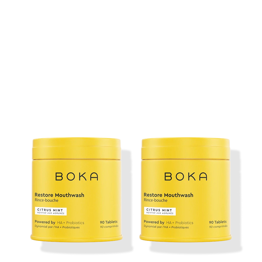 Two yellow containers of Boka Restore Mouthwash on a white background