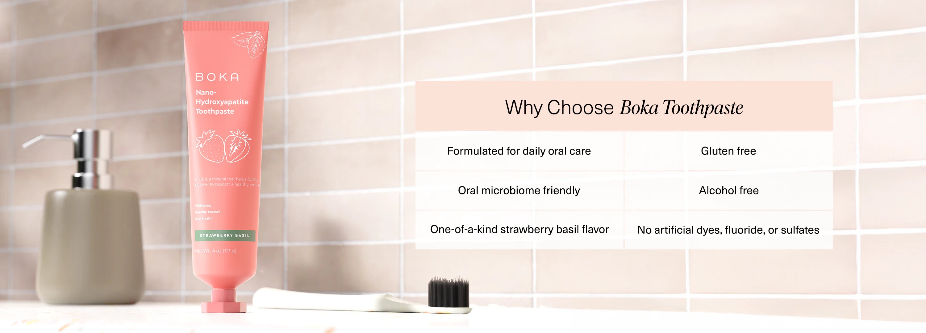 Boka Strawberry Basil toothpaste and toothbrush on a bathroom counter with product benefits listed.