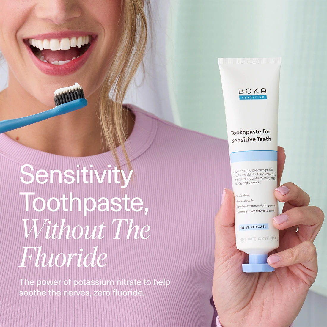 Person holding a tube of Boka toothpaste for sensitive teeth with text about sensitivity toothpaste without fluoride.