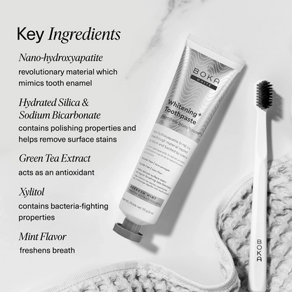 Boka Whitening Toothpaste tube with toothbrush on a marble background