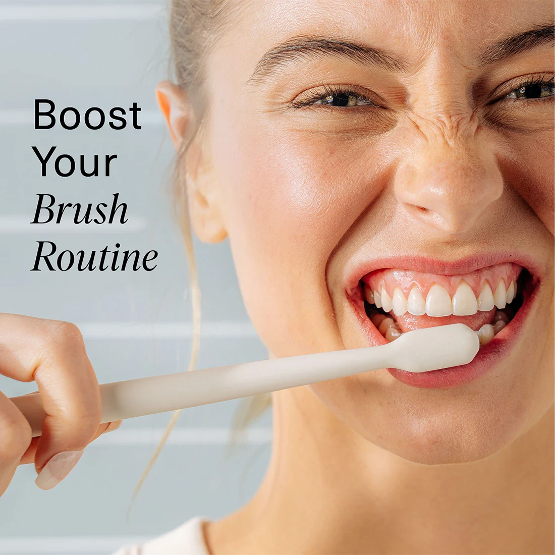Woman brushing her teeth with a toothbrush, text 'Boost Your Brush Routine' on a light blue background