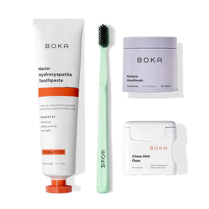 Advanced Kit: Boka toothpaste (safe if ingested), toothbrush, floss, and mouthwash tablets on white.