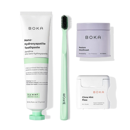 Boka Advanced Kit with kids toothpaste, toothbrush, mouthwash tablets, and floss on white background.