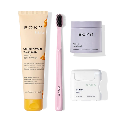 The Advanced Kit includes Boka toothpaste, a pink toothbrush, Restore Mouthwash, and Ela Mint Floss.