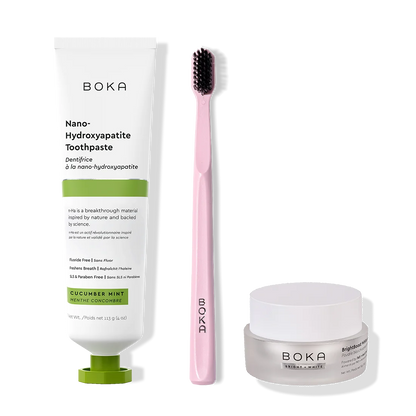 Boka toothpaste, toothbrush, and whitening powder on a white background