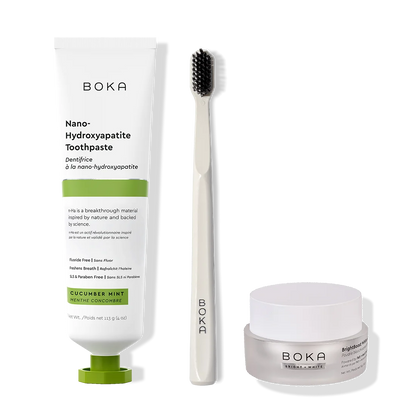Boka toothpaste, toothbrush, and whitening powder on a white background