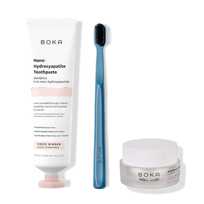 Boka toothpaste, toothbrush, and whitening powder on a white background