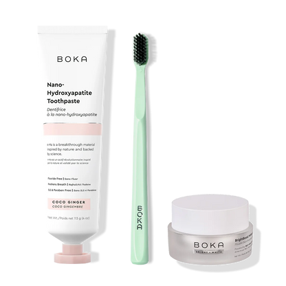 Boka toothpaste, toothbrush, and whitening powder on a white background