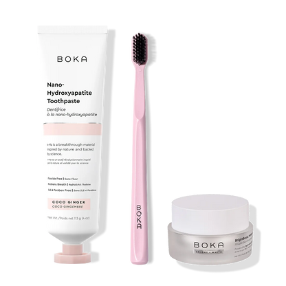 Boka toothpaste, toothbrush, and whitening powder on a white background