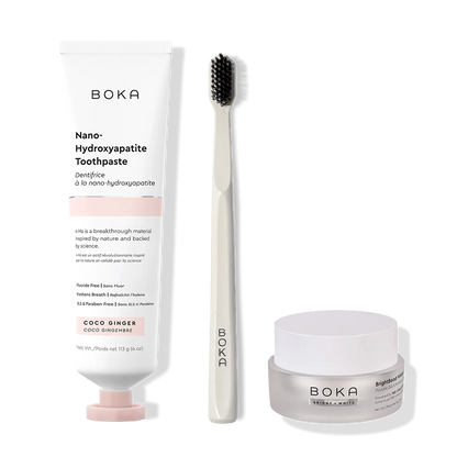 Boka toothpaste, toothbrush, and whitening powder on a white background