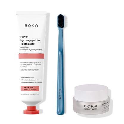 Boka toothpaste, toothbrush, and whitening powder on a white background