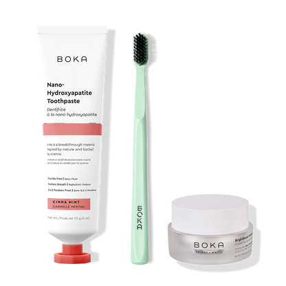 Boka toothpaste, toothbrush, and whitening powder on a white background