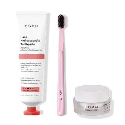 Boka toothpaste, toothbrush, and whitening powder on a white background