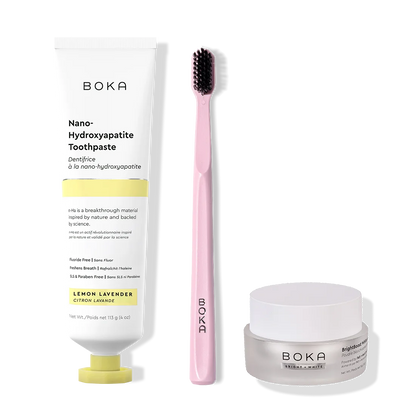 Boka toothpaste, toothbrush, and whitening powder on a white background