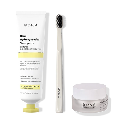 Boka toothpaste, toothbrush, and whitening powder on a white background