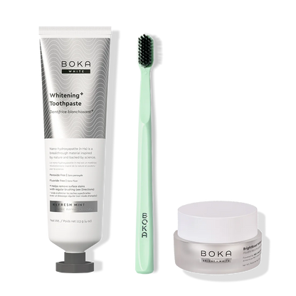 Boka toothpaste, toothbrush, and whitening powder on a white background
