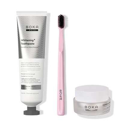 Boka toothpaste, toothbrush, and whitening powder on a white background