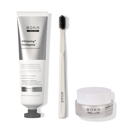 Boka toothpaste, toothbrush, and whitening powder on a white background