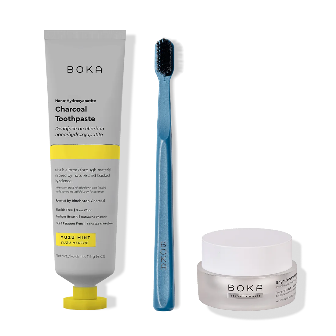 Boka toothpaste, toothbrush, and whitening powder on a white background