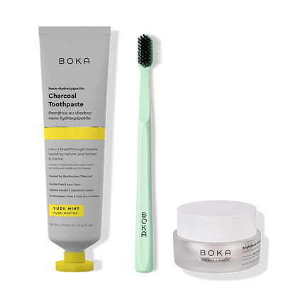 Boka toothpaste, toothbrush, and whitening powder on a white background