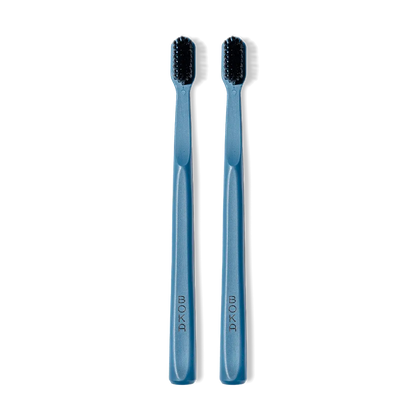 Classic Toothbrush 2-Pack: two blue brushes with charcoal bristles for a gentle clean, side by side.