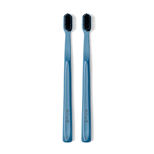 Classic Toothbrush 2-Pack: two blue brushes with charcoal bristles for a gentle clean, side by side.