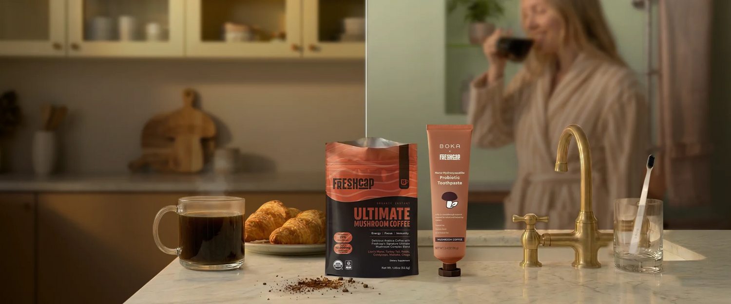Freshcap coffee package next to an orange toothpaste tube on the kitchen counter with a blurred background