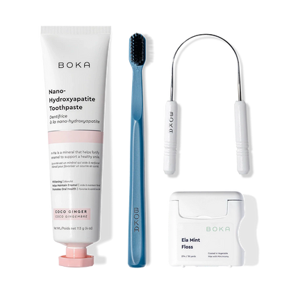 Starter Kit: toothpaste, blue charcoal toothbrush, tongue cleaner & mint floss on white background.
