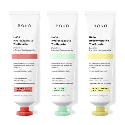 Three bottles of Boka Nano-Hydroxyapatite Toothpaste with different colored caps on a white background.