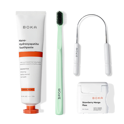 Boka Starter Kit with toothpaste, toothbrush, floss, and tongue scraper on a white background.