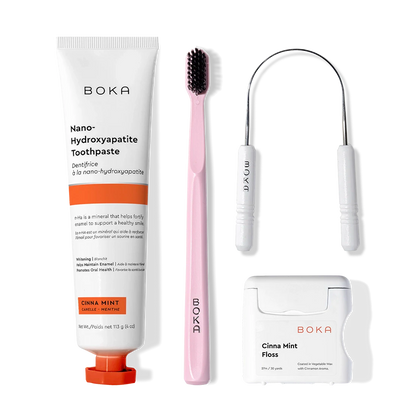 Starter Kit: toothpaste, pink brush with charcoal bristles, floss, and a tongue cleaner.