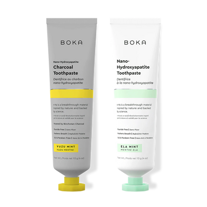 Two Boka toothpaste tubes, one with charcoal flavor and the other with mint flavor, on a white background.