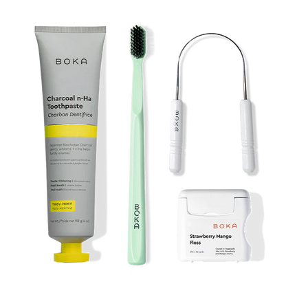 Boka Starter Kit with nano-hydroxyapatite toothpaste, charcoal toothbrush, floss, and dental tool.