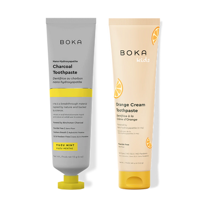 Two Boka toothpaste tubes, one gray and one beige, on a white background.