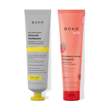 Two Boka toothpaste tubes, one Charcoal and one Strawberry Mango, on a white background.