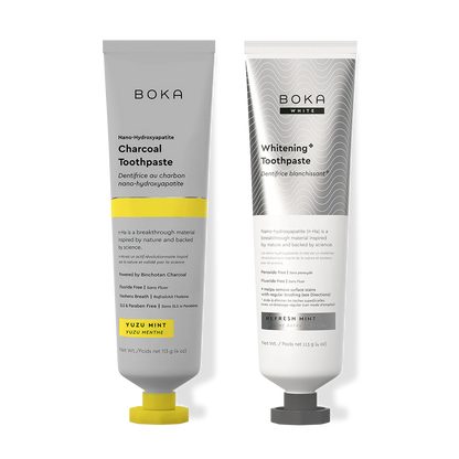 Two Boka toothpaste tubes, one Charcoal and one Whitening, on a white background.