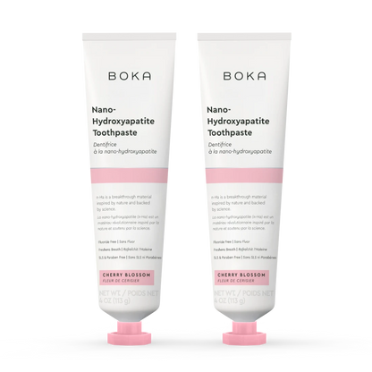 Two tubes of Boka Nano-Hydroxyapatite Toothpaste with cherry blossom flavor on a white background