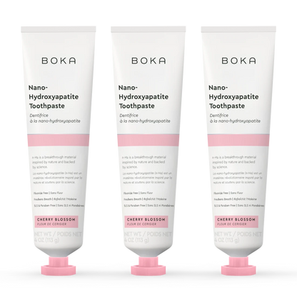 Three tubes of Boka Nano-Hydroxyapatite Toothpaste with cherry blossom flavor on a white background.