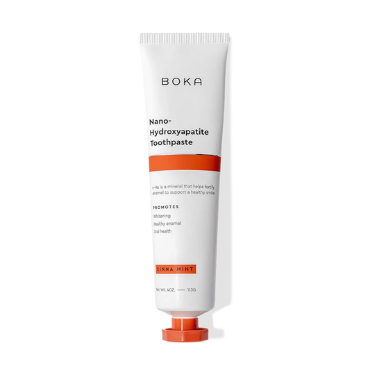 A white and orange tube of Cinna Mint n-Ha Toothpaste with nano-hydroxyapatite to remineralize teeth.