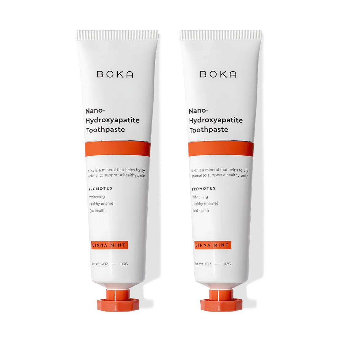 Two tubes of Cinna Mint n-Ha Toothpaste for remineralizing teeth, in orange and white packaging.
