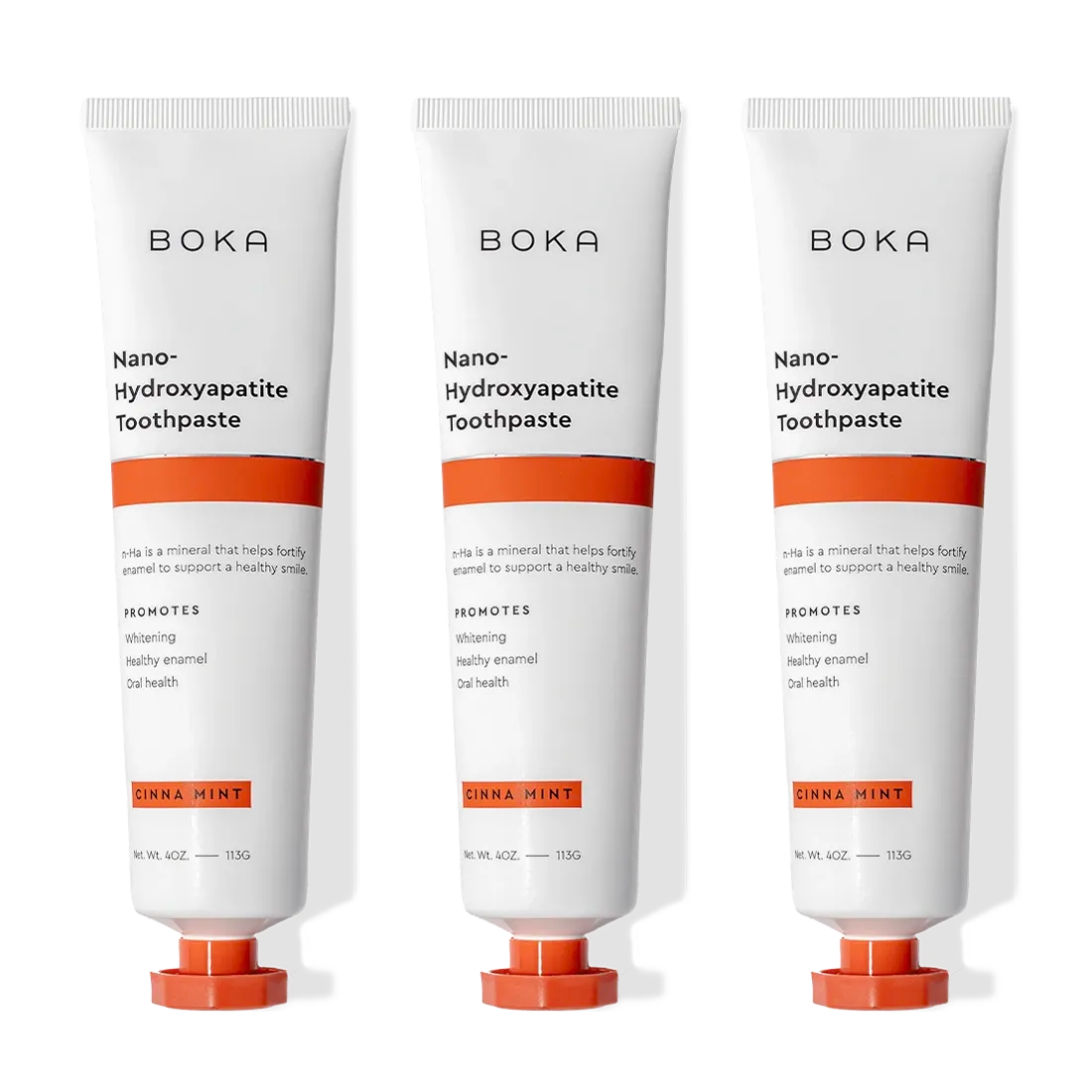 Three tubes of Cinna Mint n-Ha Toothpaste to remineralize teeth with orange cinnamon mint flavor.