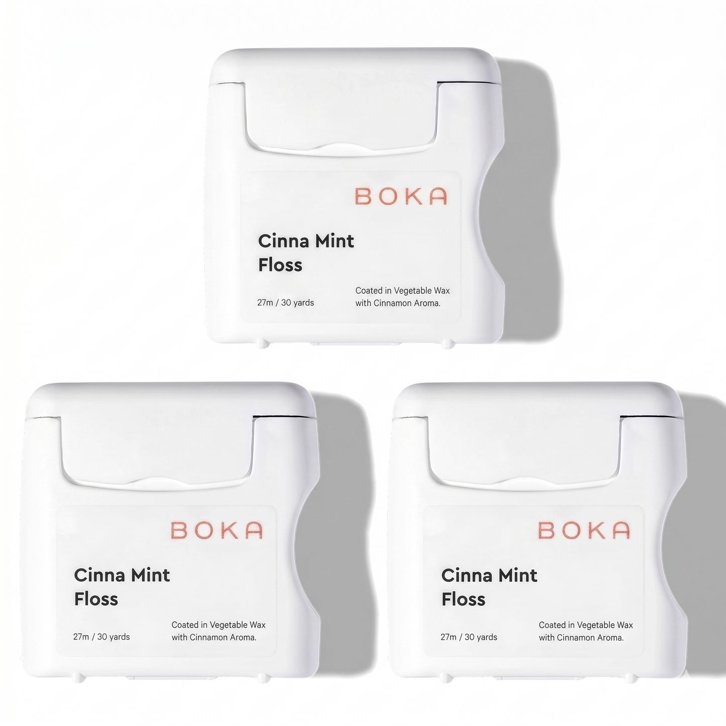 Three packages of Boka Cinna Mint Floss on a white background