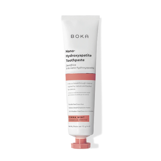 A tube of Cinna Mint n-Ha Toothpaste, fluoride free, in orange flavor stands upright.