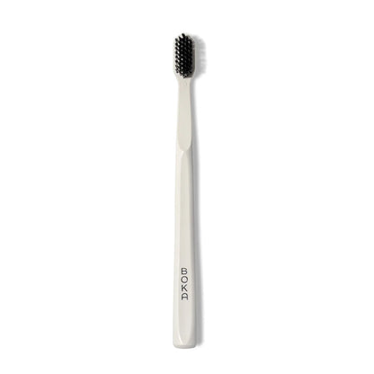 Classic Toothbrush with activated charcoal bristles; BOKA logo printed on white handle.