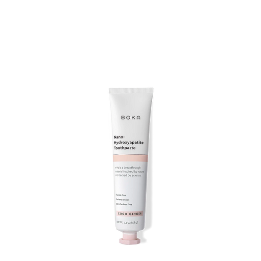 A tube of Coco Ginger Travel Size n-Ha Toothpaste on a plain background.