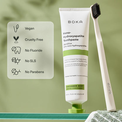 Boka toothpaste tube with a toothbrush on a green background