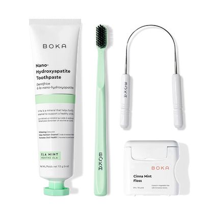 Starter Kit: toothpaste, green brush with charcoal bristles & tongue cleaner on white.