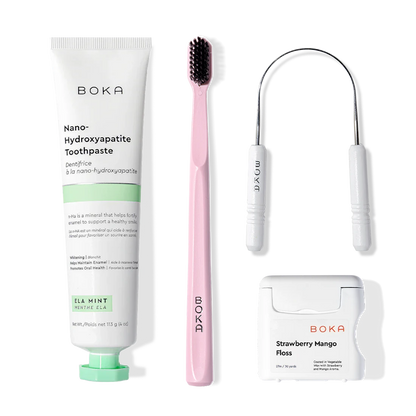Starter Kit: pink toothbrush, floss, floss pick, and nano-hydroxyapatite toothpaste on white.