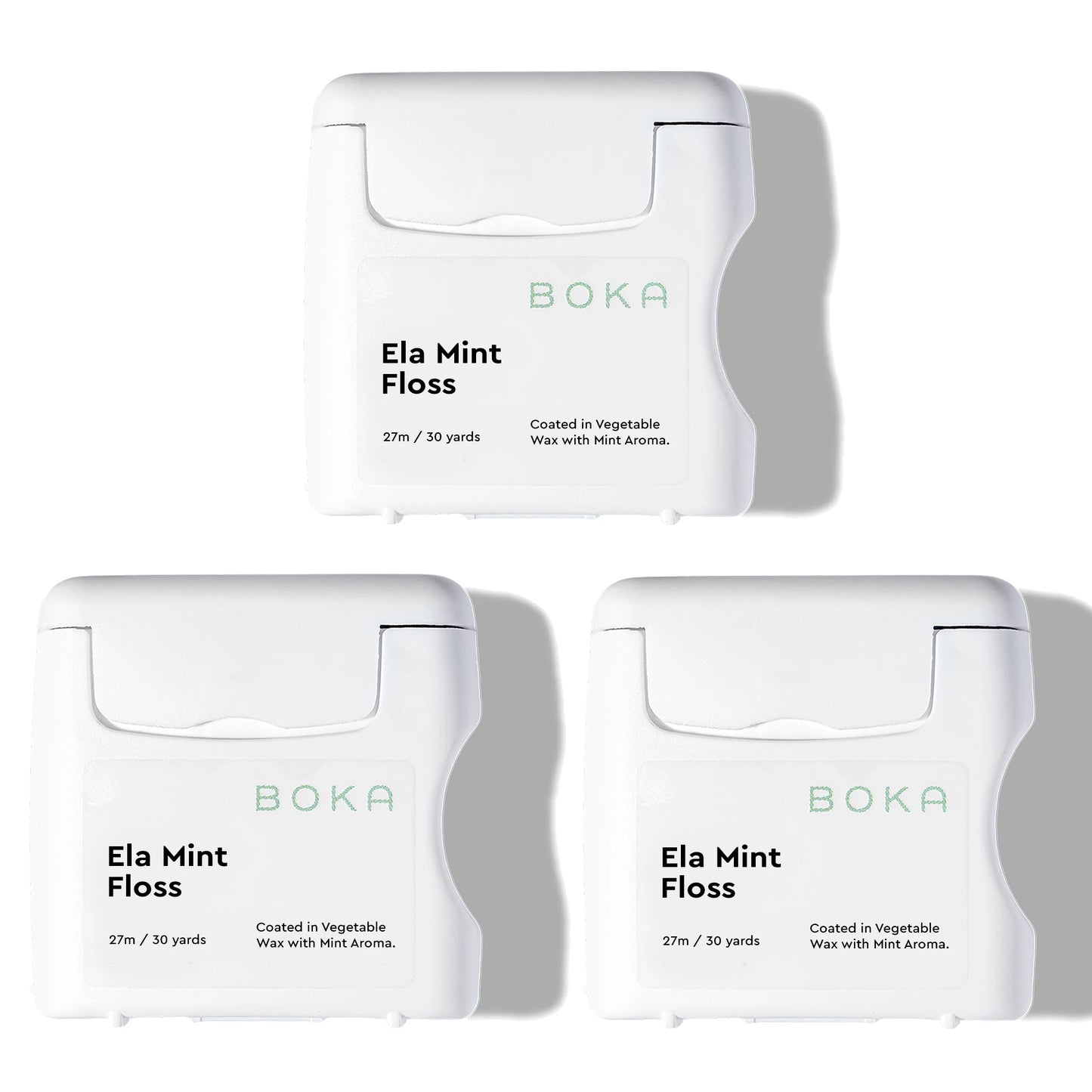 Three packages of Boka Ela Mint Floss on a white background